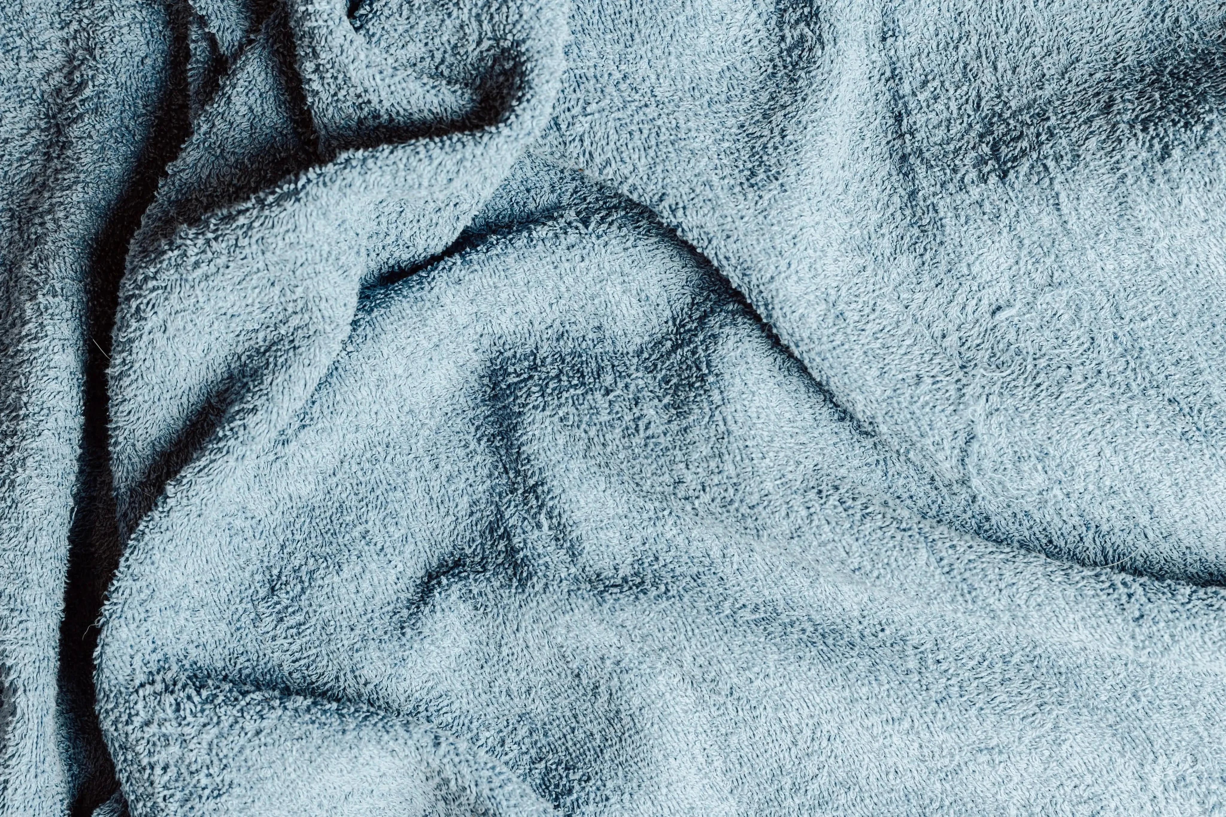 A blue terry cloth towel neatly folded.
